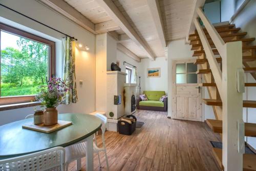 a small living room with a table and chairs and a staircase at Agroturystyka Wesoła Chmura - dom w Masywie Śnieżnika in Kletno