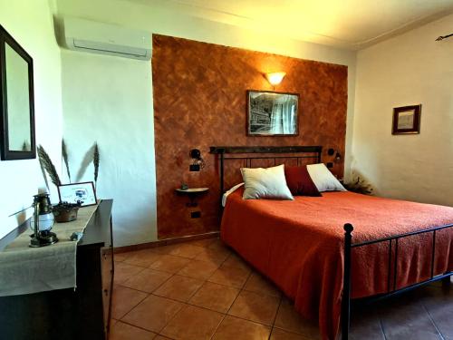 a bedroom with a bed and a desk in it at I Castagnini in Montecatini Val di Cecina