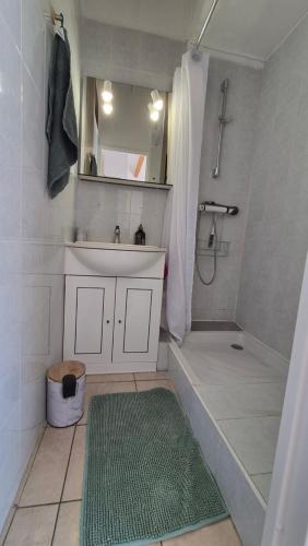 a bathroom with a sink and a shower and a tub at Les Cigalines très proche village natu in Cap d'Agde