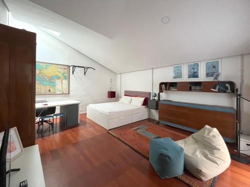 a living room with a bed and a desk at Trìcora Sicilian B&B in Catania