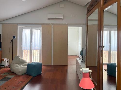 a living room with a mirror and a television at Trìcora Sicilian B&B in Catania