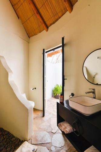 a bathroom with a sink and a mirror at Sambiya River Lodge in Murchison Falls National Park
