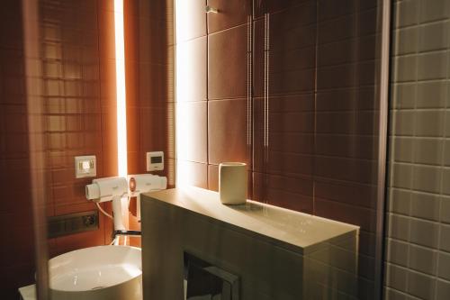 a bathroom with a sink and a mirror at Камінь in Ostrovets