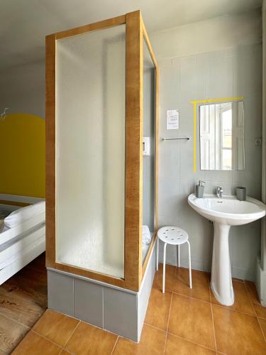 a bathroom with a sink and a mirror at A Beira Hostel in Aveiro