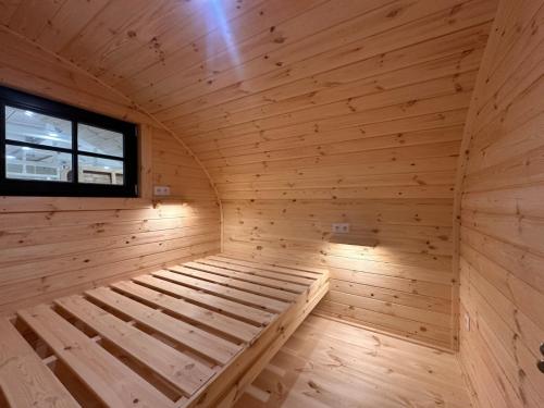 a wooden sauna with a bed in it at POD mit Bad 81 in Hüde