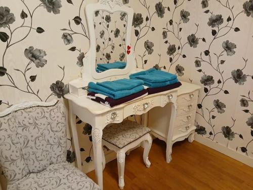 a white dressing table with a mirror and a chair at Sleeps10-PrivatePool-GamesRoom-GatedGardens in Paizay-le-Chapt