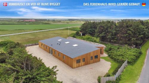 an overhead view of a wooden building with a roof at Eksklusivt Luksusferiehus Med Pool Sj455 in Harboør