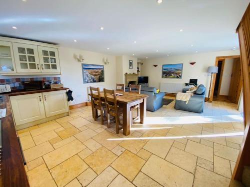 a kitchen and living room with a table and chairs at Hollow Brook grown ups escape peace and quiet in Eyam