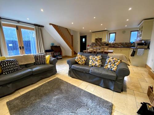 a living room with two couches and a kitchen at Hollow Brook grown ups escape peace and quiet in Eyam