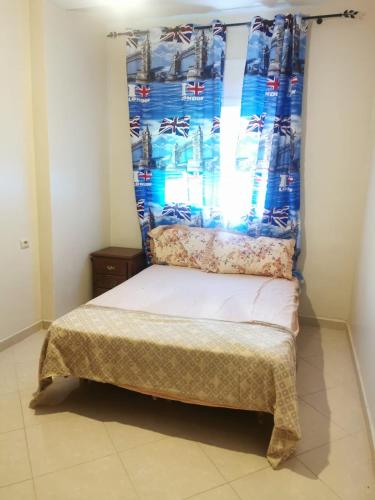 a small bed in a room with a window at Martil calm apartment in Martil