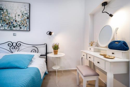 a bedroom with a bed and a desk and mirror at Hvar Villa Maris in Hvar
