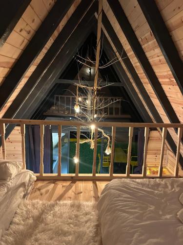 a room with a bed and a large window at Peak ayder bungalow in Ayder Yaylasi
