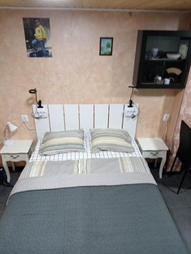 a bedroom with a large white bed with two tables at Apartment by the park in Imatra