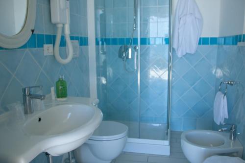 a bathroom with a sink and a toilet and a shower at Hotel Ristorante Maga Circe in San Felice Circeo