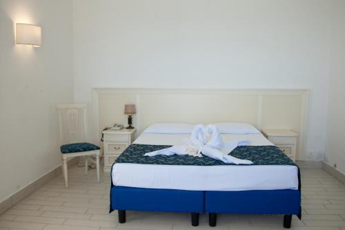 a bedroom with a bed with a towel on it at Hotel Ristorante Maga Circe in San Felice Circeo