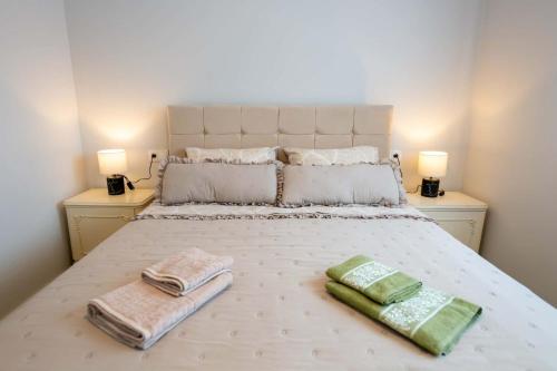 a bedroom with a bed with two towels on it at Amfithea Guest House in Amfithea