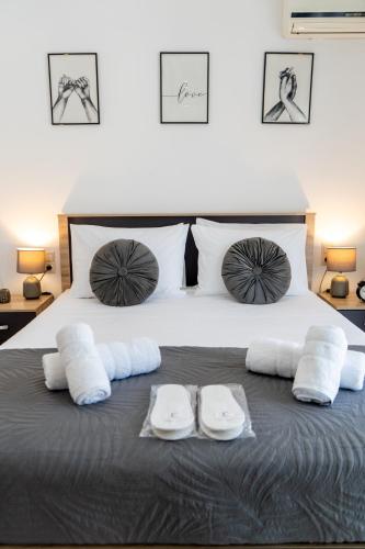 a bedroom with a bed with two towels on it at Fos Opus - Seaside Residence Rhodes in Ixia
