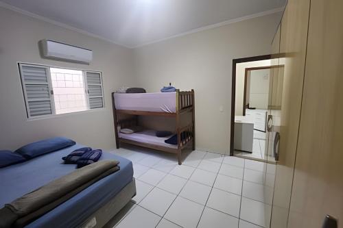 a bedroom with a bunk bed and a mirror at Campo Grande Guest Flat in Campo Grande