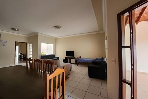 a living room with a couch and a table at Campo Grande Guest Flat in Campo Grande