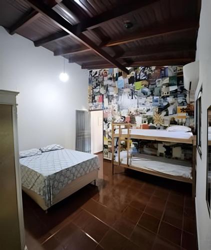 a room with a bed and a table in it at Dourados Guest Flat, your choice in Dourados-MS. in Dourados