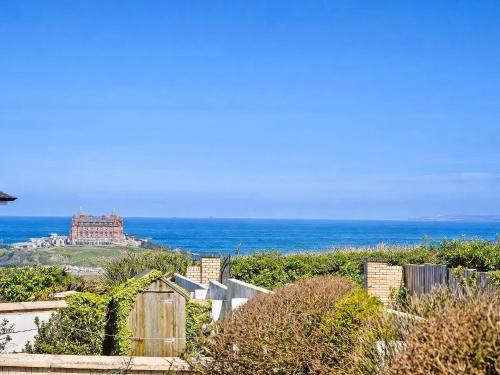 a view of the ocean with a castle in the distance at Headland Views in Newquay
