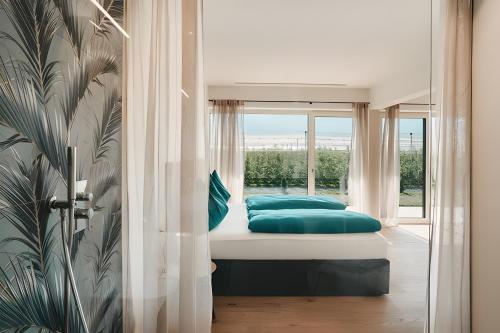 a bedroom with a bed and a window at New Opening Grafferhof in Bolzano