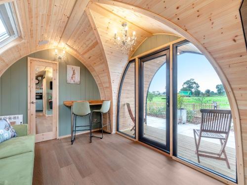 an arched room with a large window and a table at The Warren - Uk47582 in Sutton on the Hill