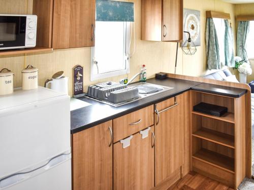 a small kitchen with a sink and a stove at Beech Walk 45 - Ukc9406 in Exmouth
