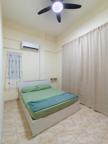 a bedroom with a bed and a ceiling fan at TBSC by Reemon in Keningau