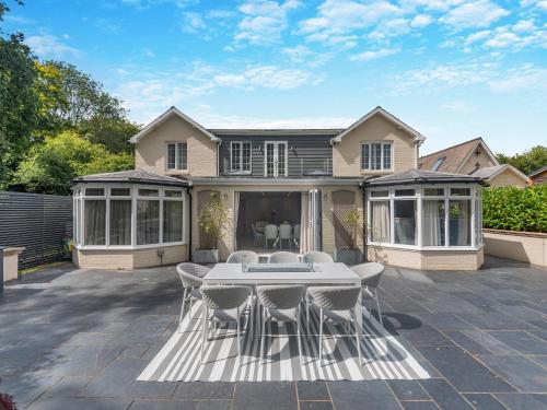 a house with a patio with a table and chairs at Woodlea Farm in Four Marks
