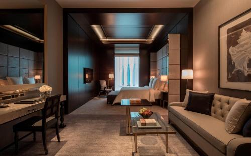 a living room with a couch and a bed at Four Seasons Hotel London at Tower Bridge in London