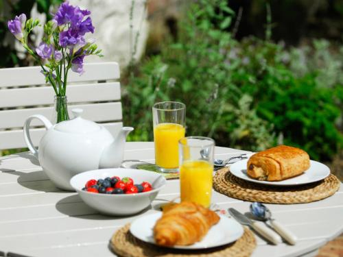 a table with a breakfast of croissants and orange juice at Pemberly in Winchester