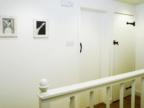 a hallway with white walls and a white door at Pemberly in Winchester