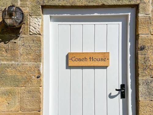 a door with a sign that reads coach house at Coach House - Uk51830 in Great Ayton