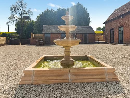 a water fountain in the middle of a courtyard at Fountain Front Barn - Uk45937 in Corley