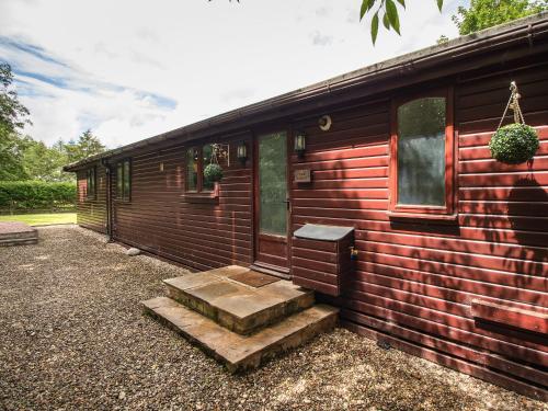 a wooden cabin with stairs leading to the door at The Lodge - Uk13202 in Cayton