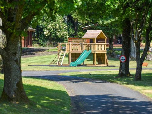 a playground with a slide in a park at Willow Lodge in Ingleton