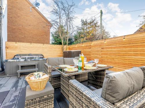 a patio with a table and chairs and a grill at West House in Wooler