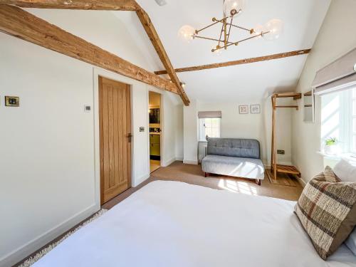 a bedroom with a bed and a couch at Stables - Uk51829 in Great Ayton