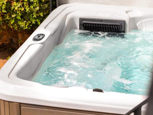 a jacuzzi tub with blue water in it at Killerby Old Hall - Uk47711 in Cayton