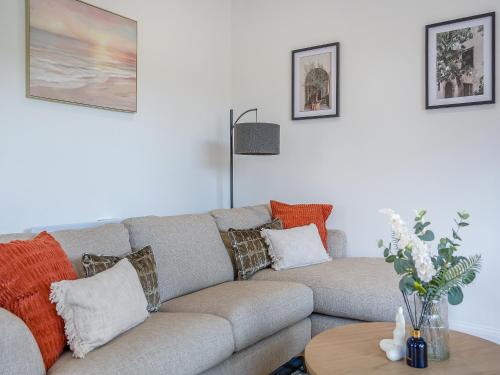 a living room with a couch and a table at Trig View - Uk49915 in Bardon Mill