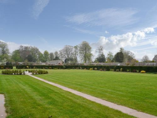 a large grassy field with a pathway in it at Grieve's Cottage - Uk11107 in Montrose