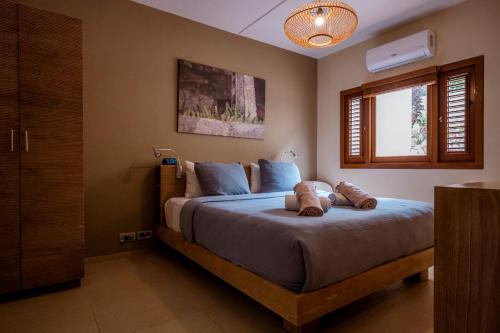 a bedroom with a bed with two pillows on it at Luxury Ocean View Apartment, Private Beach, Infinity Pool, near Jan Thiel C3 in Willemstad