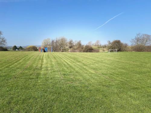 a field with a kite in the middle of a field at Ashtree Hideaway in Brandon