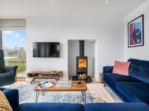 a living room with a blue couch and a fireplace at Willowmere in Dorchester