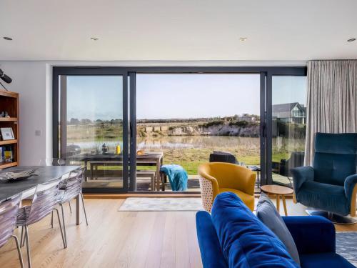 a living room with a blue couch and chairs at Willowmere in Dorchester