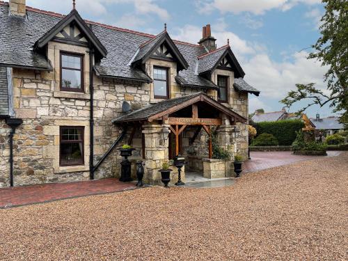an old stone house with a large entrance at Tennox Farm House - Uk36254 in Kilbirnie