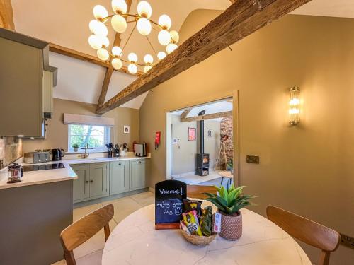 a kitchen and dining room with a table and chairs at Gardeners Cottage - Uk51831 in Great Ayton
