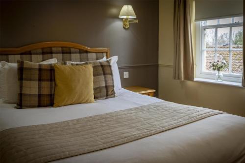 a bedroom with a large bed with a window at York Pavilion Hotel, BW Signature Collection in York
