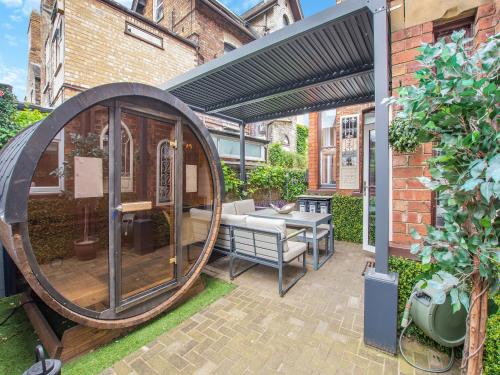 an outdoor patio with a large wooden circle with a table at Jorvik Villas in York